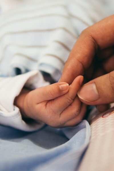 mother's hand holding a newborn hand